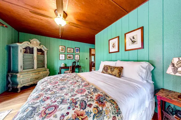 Master bedroom with king bed with and wall to ceiling feelings.