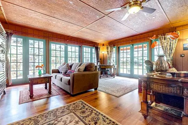 Living room with French windows and doors encircle the entire perimeter.  Sofa bed for extra guests.