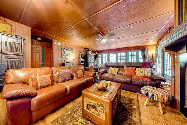 Living room with French windows and doors encircle the entire perimeter.  Sofa bed for extra guests.