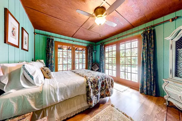 Master bedroom with king bed with and wall to ceiling feelings.