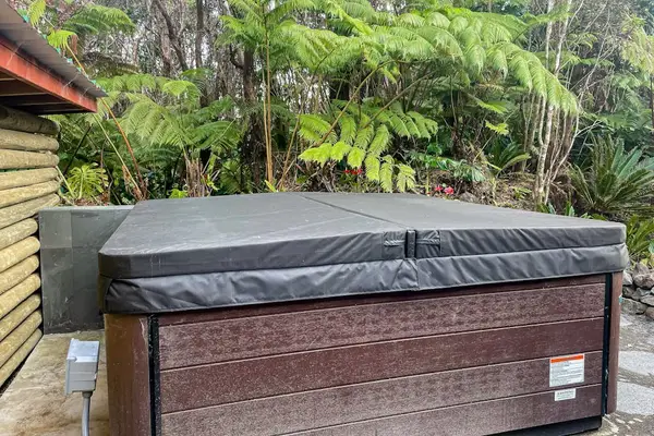 Private hot tub, perfect for unwinding after exploring Volcano National Park.