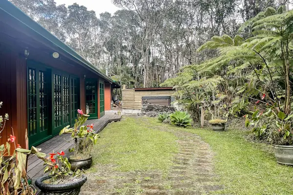 Escape to a private tropical backyard oasis surrounded by lush Hawaiian landscaping, swaying palms, and the peaceful beauty of paradise.