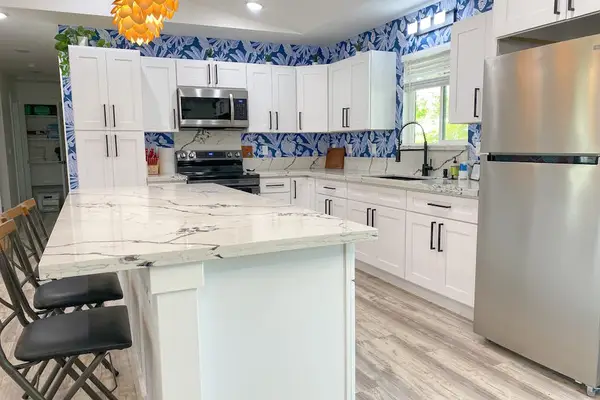Well-equipped, island kitchen complete with black stainless steel appliances, gorgeous quartz countertops, and counter seating. Prepare your favorite recipes in this spectacular space and then dine together at the adjacent table.