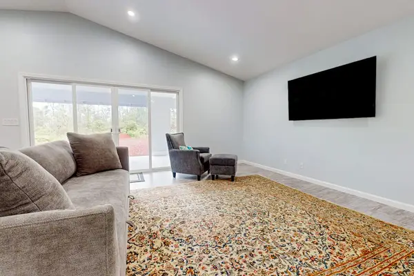 Open concept living with a sofa bed for any extra guests that stop by and a flat screen tv.