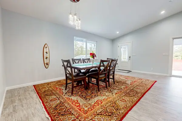 Large dining room table with seating for eight and lots of windows for that airy feel.