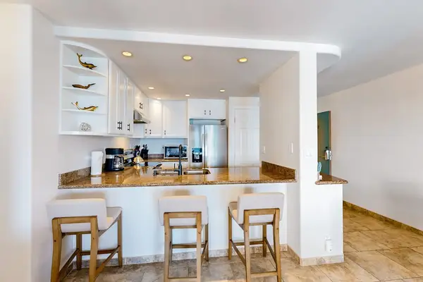 Breakfast bar with white barstools.