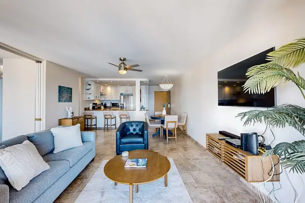 Bright living room with a balcony and a view of the ocean.