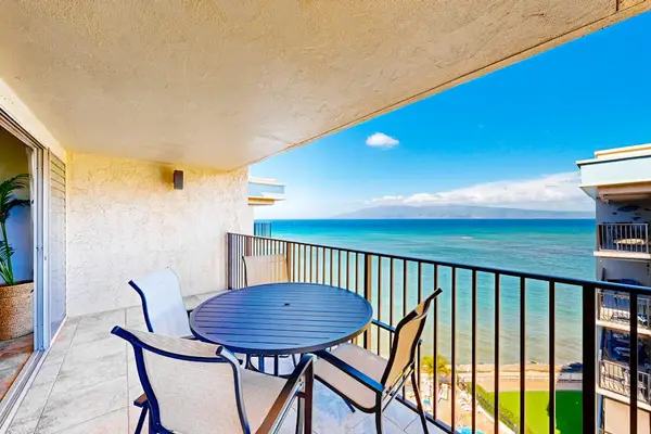 Private balcony featuring a black metal dining set with sweeping ocean views.