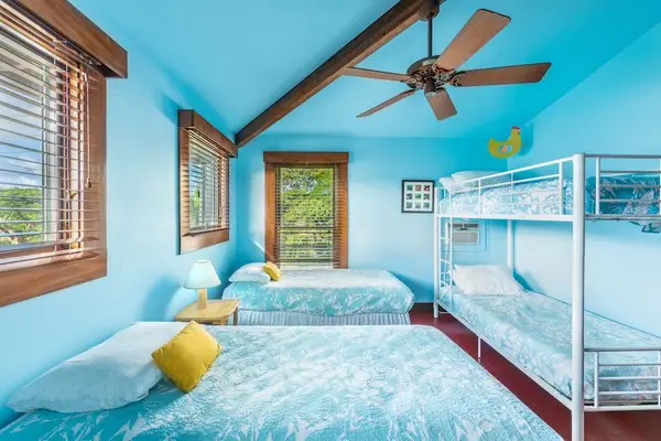 Big Bedroom combines colorful bedding, wood accents, and natural light