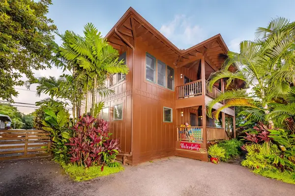 Wooden home exterior blends landscaping with welcoming architecture and balconies