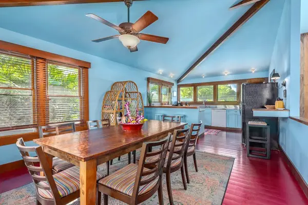 Open dining area combines seating, wood accents, and garden views