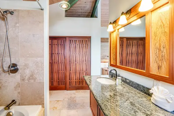 Pamper yourself! This gorgeous primary bathroom features a sprawling stone vanity, warm mirror lighting, and a modern, spacious walk-in shower! 🚿🧼✨