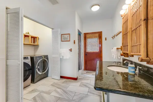 Ultimate convenience! This spacious guest bathroom features a clean vanity, bright lighting, and a modern in-unit washer and dryer setup! 🧼🧺✨