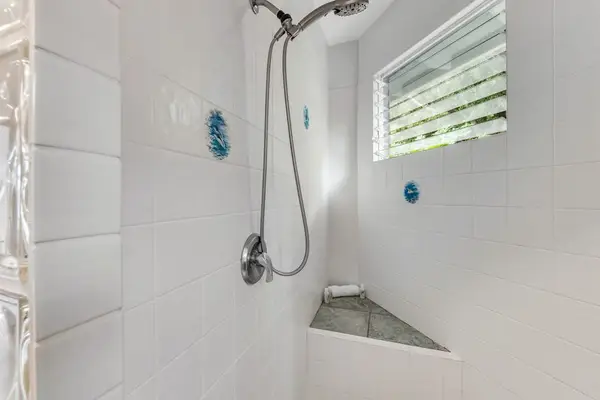 Sleek and modern! This sparkling shower space features a premium handheld shower head, clean tile finishes, and a bright, airy feel! 🚿🧴💫