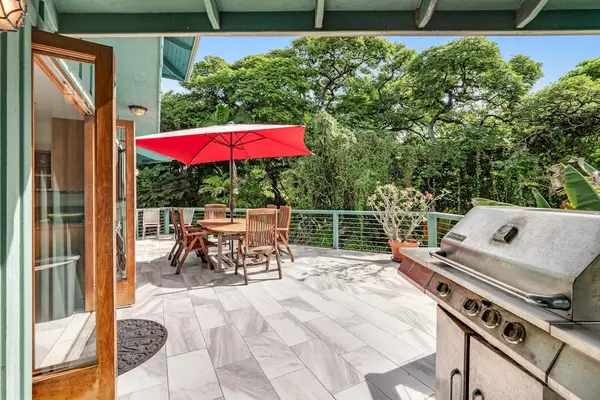 Spacious outdoor deck featuring a premium stainless steel BBQ grill, dining table, and scenic forest views. 🥩✨