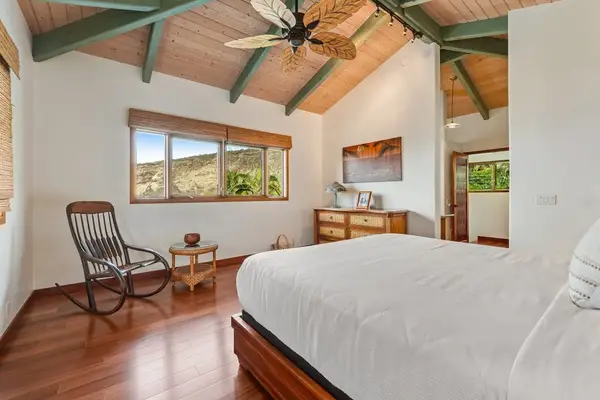 Breathe easy in this spacious bedroom featuring beautiful high vaulted ceilings, a cooling fan, and cozy corners bathed in natural light! ☀️🌀✨