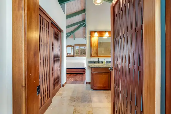 ​Step into luxury! This primary bathroom hallway features elegant wooden cabinetry leading into a beautifully lit vanity area! 🪵💡✨