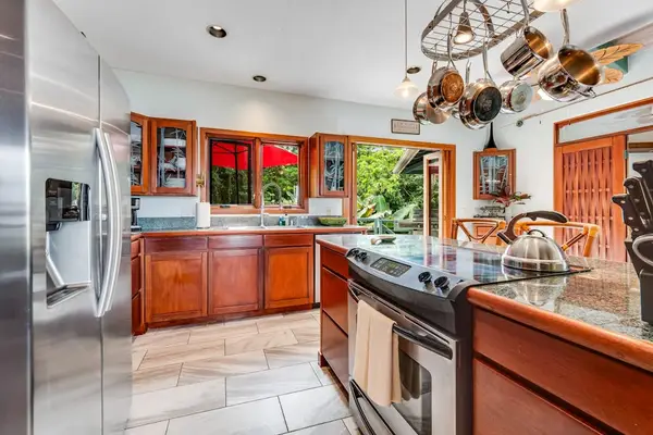 Sleek and functional! Enjoy ample counter space, a built-in island sink, and high-end wood cabinetry perfect for whipping up delicious meals! 🍳🔪✨