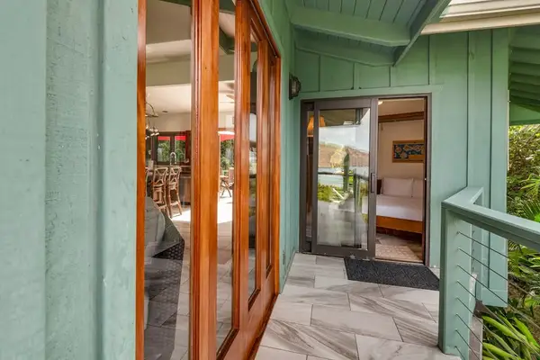 Warm timber meeting modern structure. Beautifully crafted wooden French doors stand open, highlighting the seamless transition to a private, sun-warmed balcony. 📐🪵