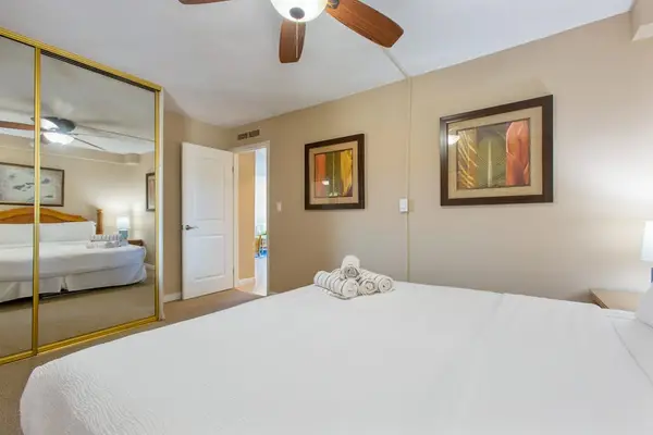 Comfortable king bedroom with mirrored closet doors