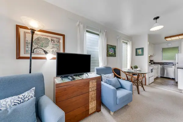 Comfortable living room with Smart TV and cozy seating.