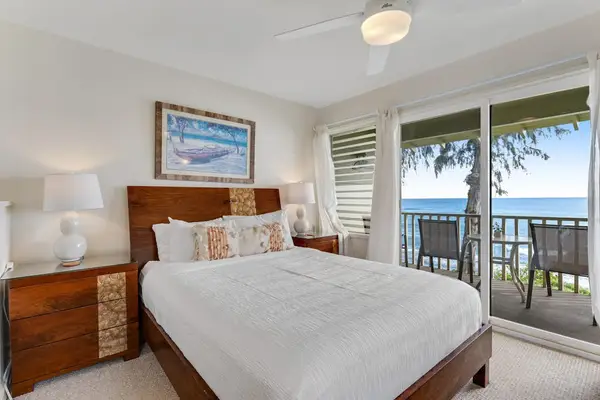 Bright bedroom with direct access to the private oceanfront lanai.