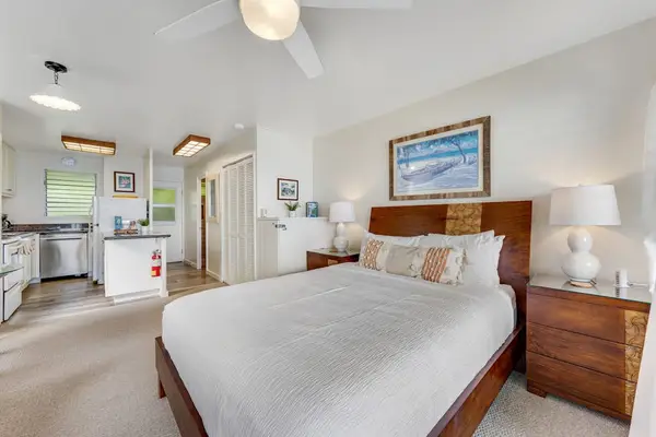 Bright bedroom with an open layout and fully equipped kitchenette.