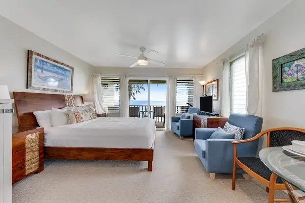 Spacious bedroom with a cozy sitting area and beautiful ocean views.