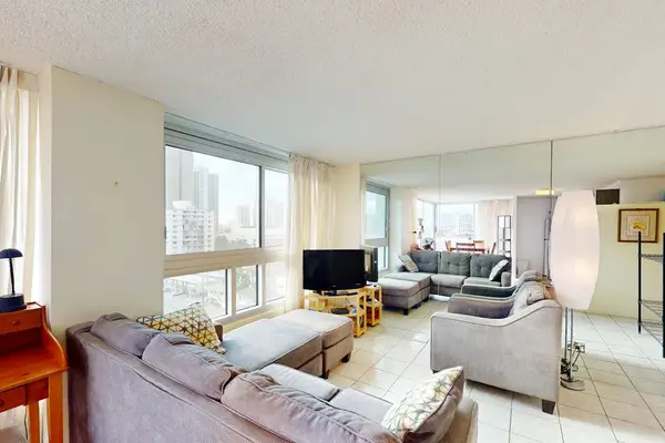Comfortable living area with city views beyond the windows