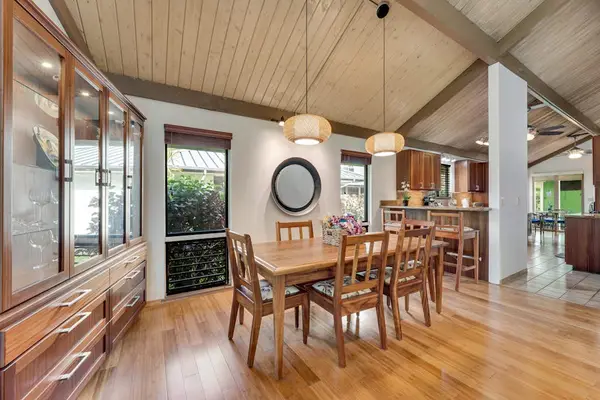 Warm dining table gathers beneath vaulted ceilings and pendant lights