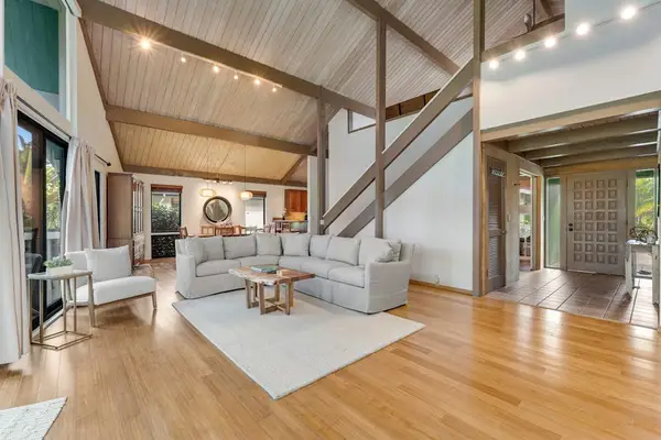 Open living space highlights soaring beams warm floors and comfort