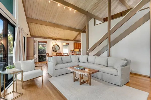 Bright seating links timber beams polished floors and garden views