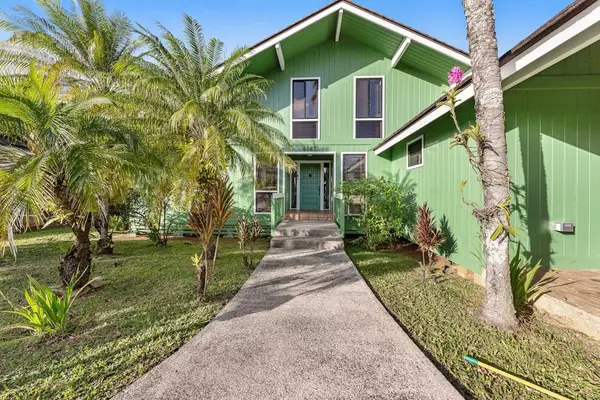 Palm lined walkway guides arrivals toward cheerful home entrance gardens