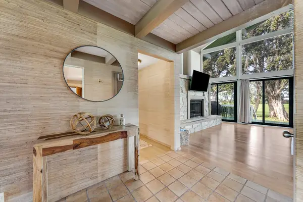 Open interior showcases tall ceilings warm wood and garden views