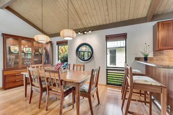 Round table welcomes memorable meals beneath warm wooden vaulted ceiling