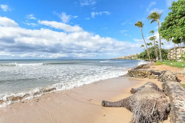Crystal-clear turquoise waters gently wash onto pristine white sandy beaches.