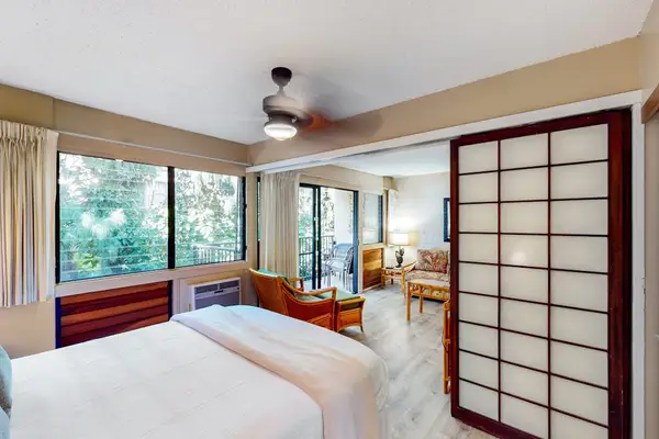Bedroom with queen size bed and en suite.  Bedroom is separated from living space with a sliding divider, allowing for privacy or a more open concept feel.