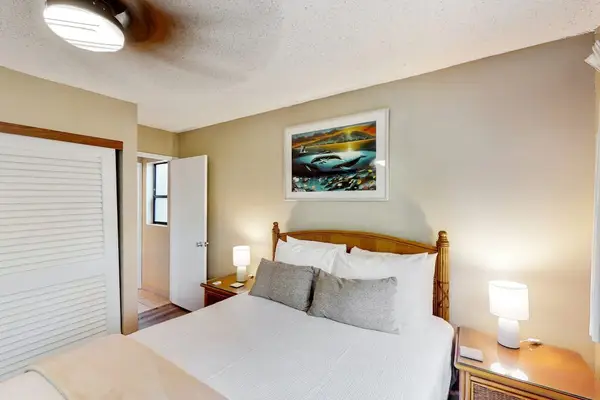 Bedroom with queen size bed and en suite.  Bedroom is separated from living space with a sliding divider, allowing for privacy or a more open concept feel.