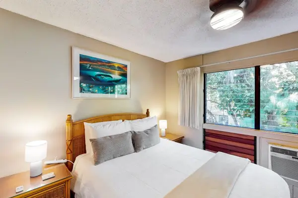 Bedroom with queen size bed and en suite.  Bedroom is separated from living space with a sliding divider, allowing for privacy or a more open concept feel.