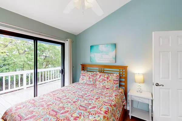 Bright Queen Bedroom featuring a large comfortable bed, bedside storage, and sliding doors with direct access to the private balcony! 🛌✨