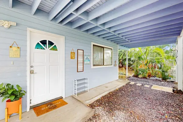 Charming front entrance featuring a covered porch, beautiful blue accent beams, and a welcoming front door setup! 🏠✨