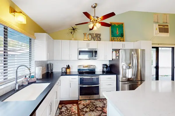 Sleek, fully equipped kitchen featuring modern stainless steel appliances, a deep double sink, and ample meal prep space! 🍳✨
