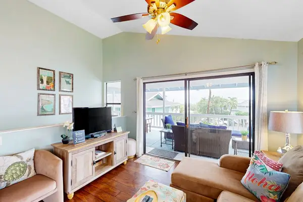 Bright living room lounge featuring a flat-screen TV, comfortable sofa seating, and large sliding doors opening to the balcony! 🛋️🌅