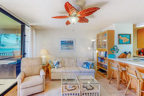 Living room with lots of natural light and an open concept feel with a flatscreen tv.  The sofa folds out for extra sleeping.