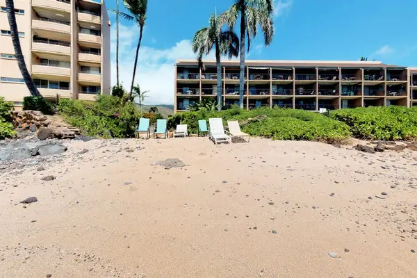 Crystal-clear turquoise waters gently wash onto pristine white sandy beaches.