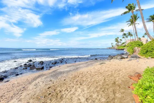 Crystal-clear turquoise waters gently wash onto pristine white sandy beaches.