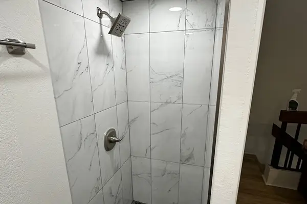 Walk-in shower with modern tile finishes