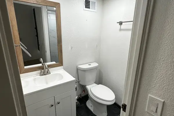 Full bathroom with vanity and shower