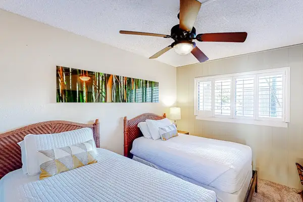 Guest room with two twin beds and a ceiling fan for your comfortable all night long.