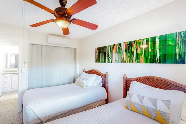 Guest room with two twin beds and a ceiling fan for your comfortable all night long.